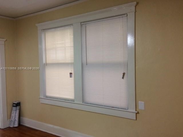 Dual window installation featuring white-painted millwork trim and light-filtering horizontal blinds