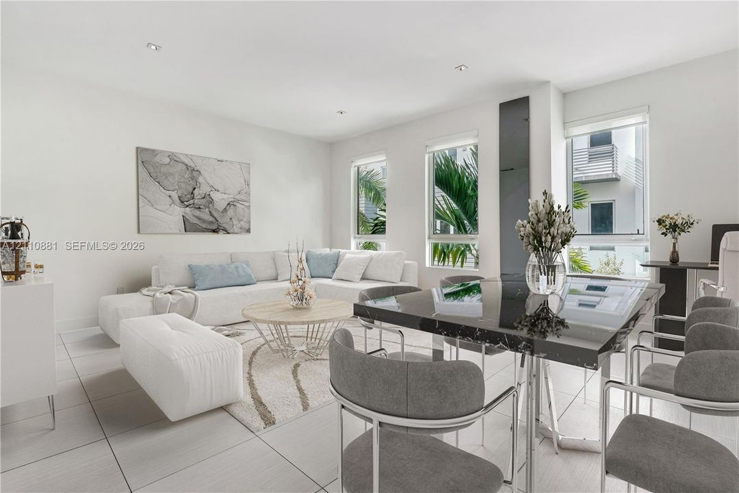 Open-concept interior featuring large-format tile flooring, recessed lighting, and multiple windows
