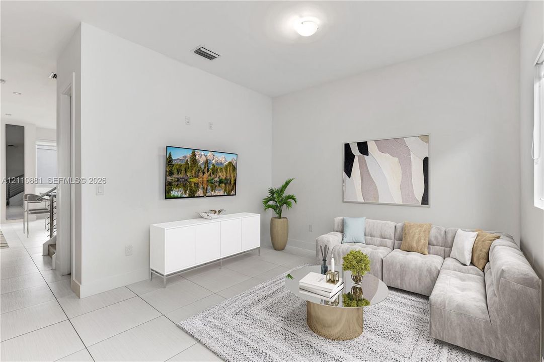 Neutral-toned interior space featuring light-colored large-format tile flooring, crisp white walls, and a recessed ceiling lighting fixture