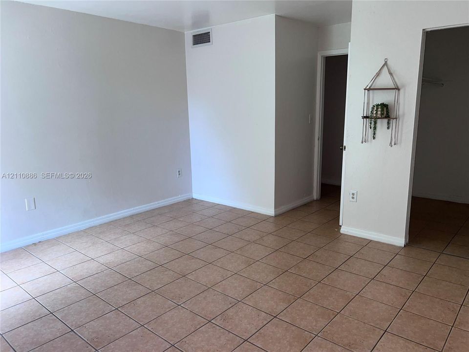 Interior room featuring neutral wall paint and tile flooring