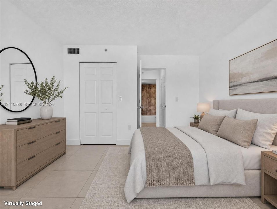 Neutral-toned interior space featuring light-colored tile flooring and a double-door closet with paneled trim