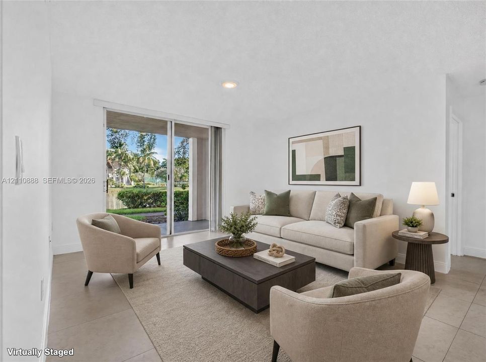 Living area featuring large-format tile flooring, recessed lighting, and sliding glass doors with access to a covered patio
