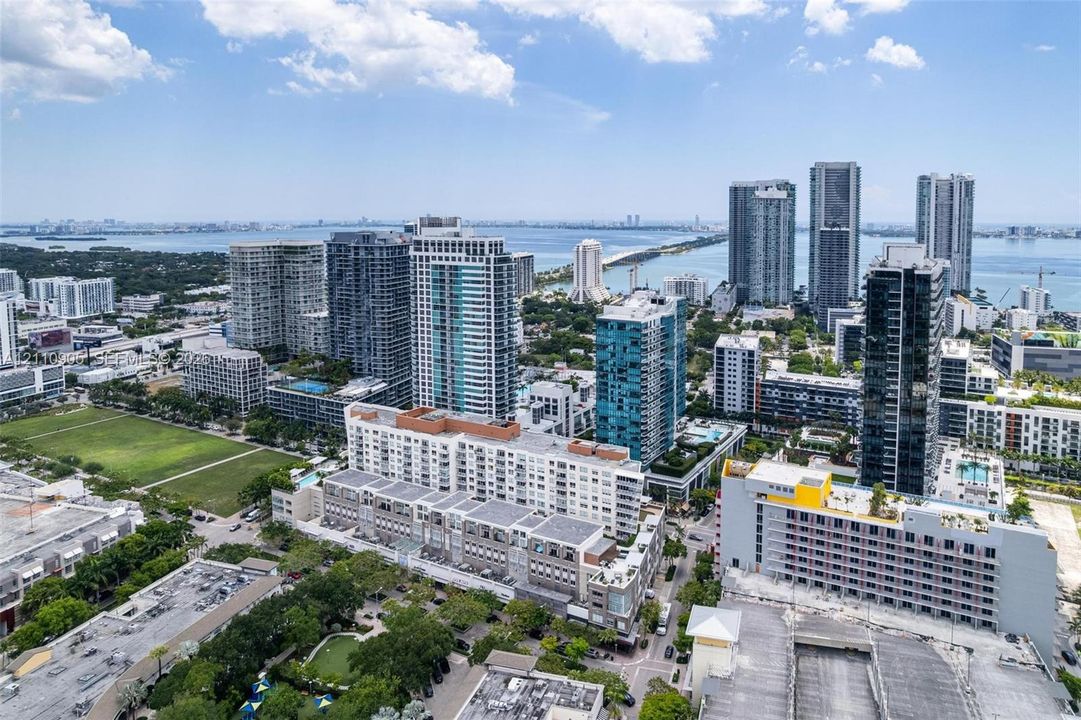 Aerial urban landscape featuring a high-density skyline, proximity to open water, and extensive metropolitan infrastructure