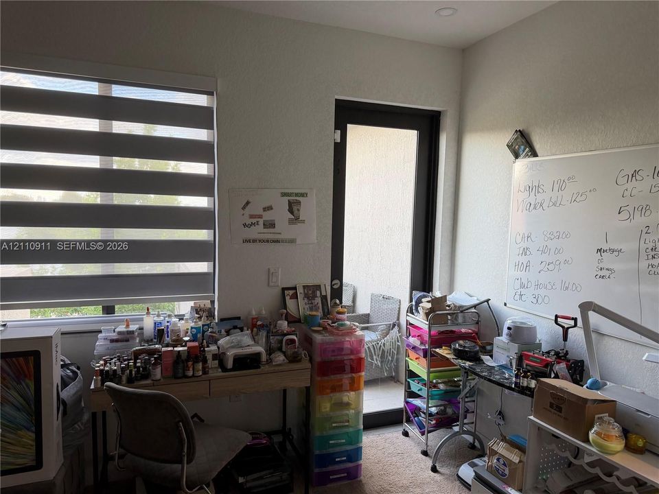 Room featuring dual-tone adjustable roller shades, recessed ceiling lighting, and a glass-paneled door with exterior access
