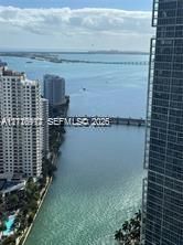 High-rise exterior with water and urban skyline scenery