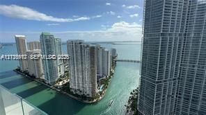 High-rise balcony featuring a glass railing and panoramic bay and urban skyline scenery