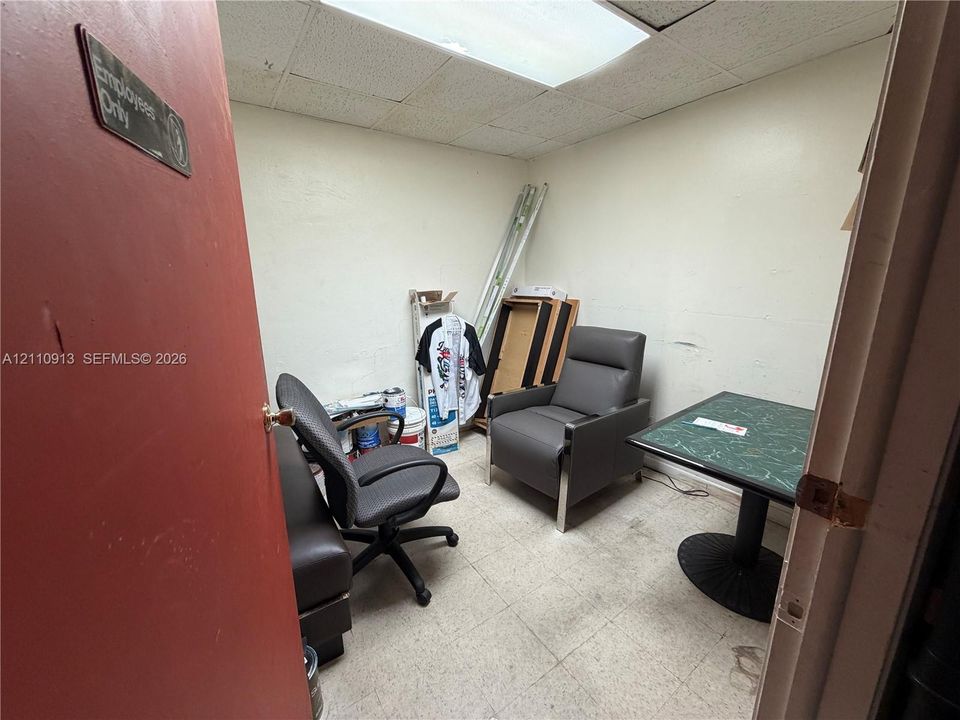 Interior room featuring white walls, a drop ceiling with recessed lighting, and tile flooring