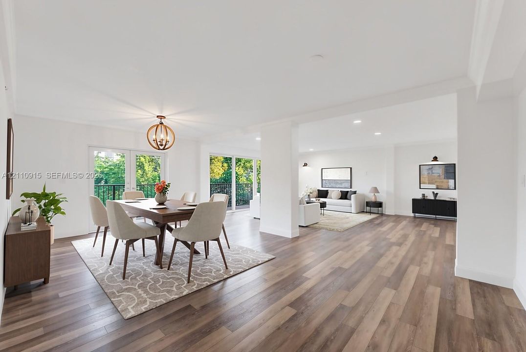 Open-concept living space featuring wood-finish flooring, recessed lighting, a modern geometric orb chandelier, and double glass doors opening to a balcony