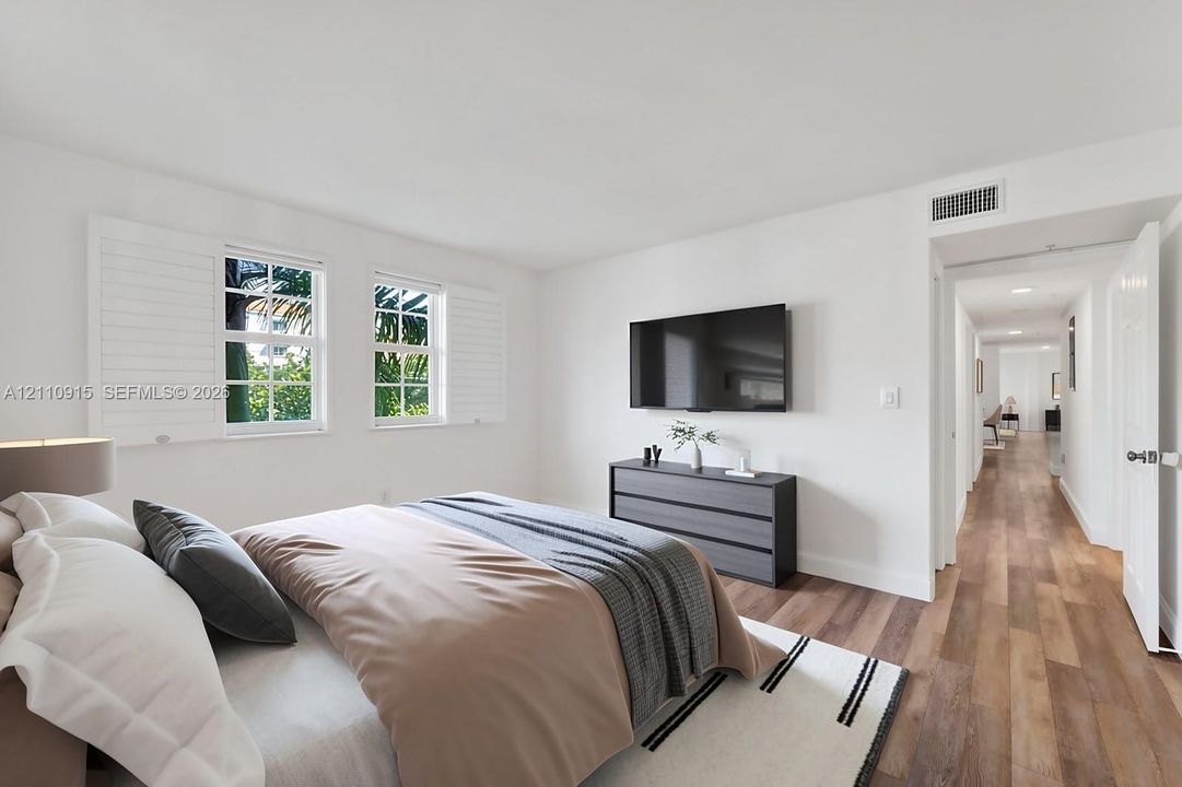Interior space featuring wood-finish flooring, white walls, dual windows with plantation shutters, and recessed lighting