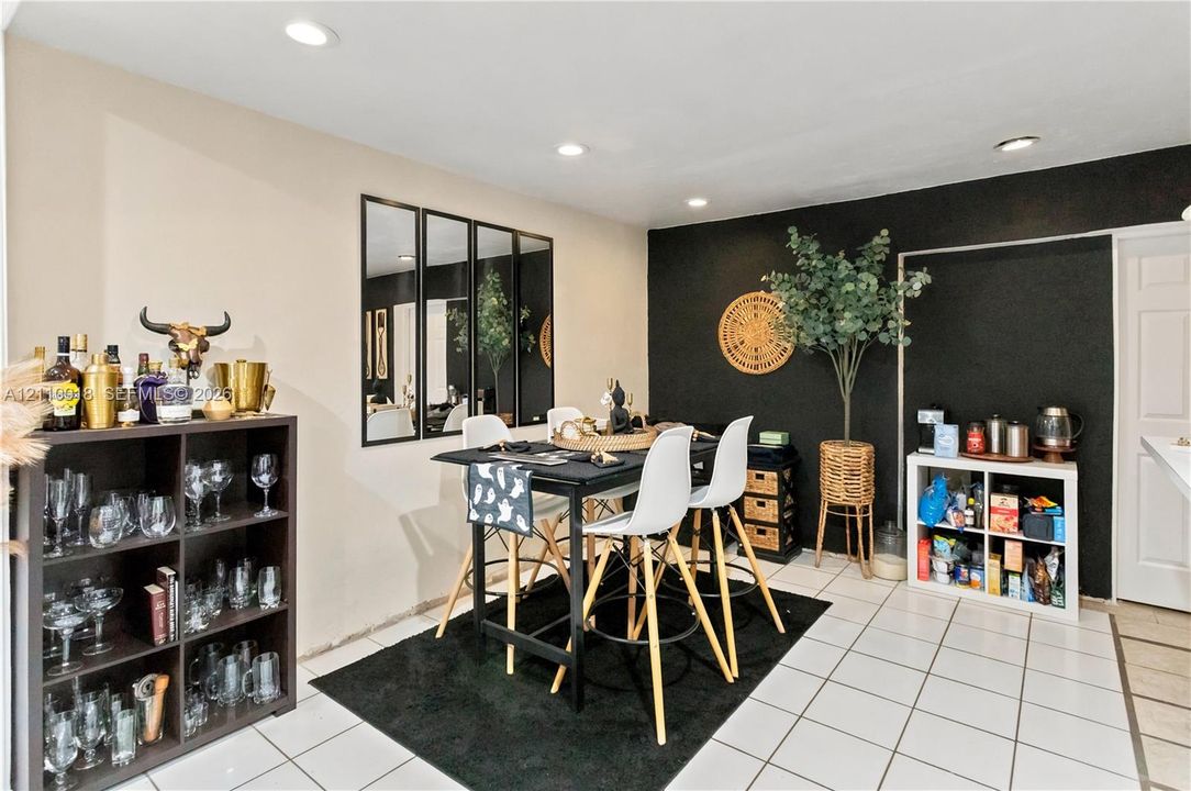 Ceramic tile flooring, recessed ceiling lighting, and a multi-panel wall mirror