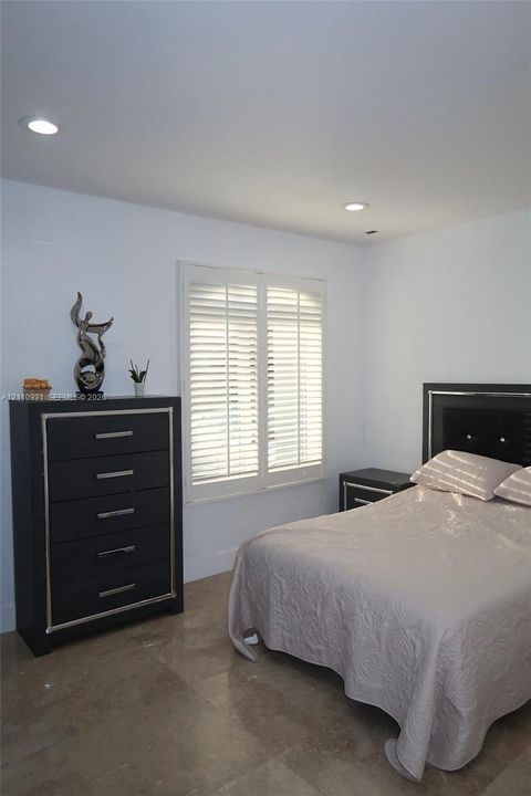 Room featuring tile flooring, white plantation shutters, and recessed ceiling lighting