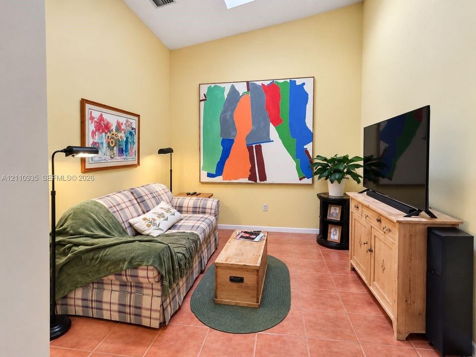 Vaulted ceiling, skylight, and large-format ceramic tile flooring