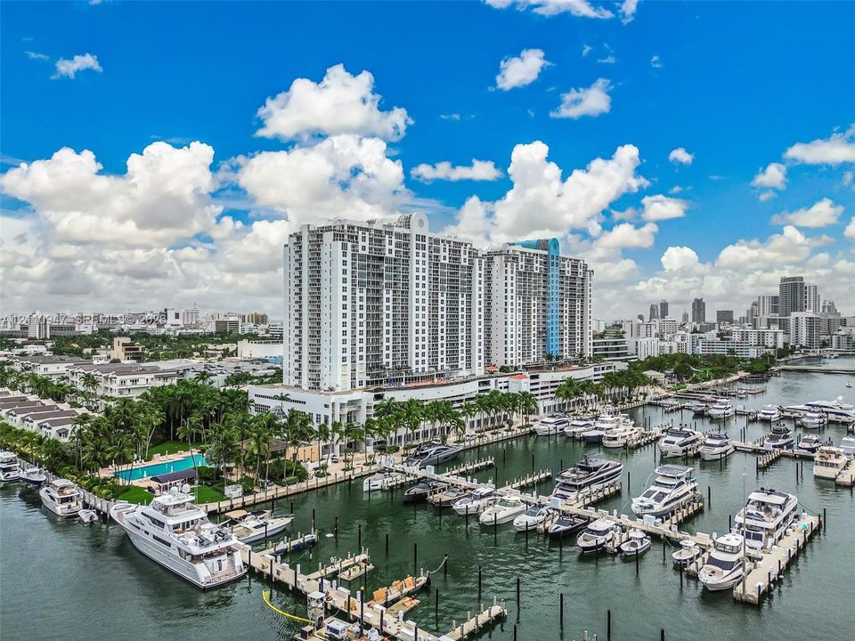 High-rise residential building featuring expansive waterfront access, private deep-water docking slips, and outdoor swimming pool