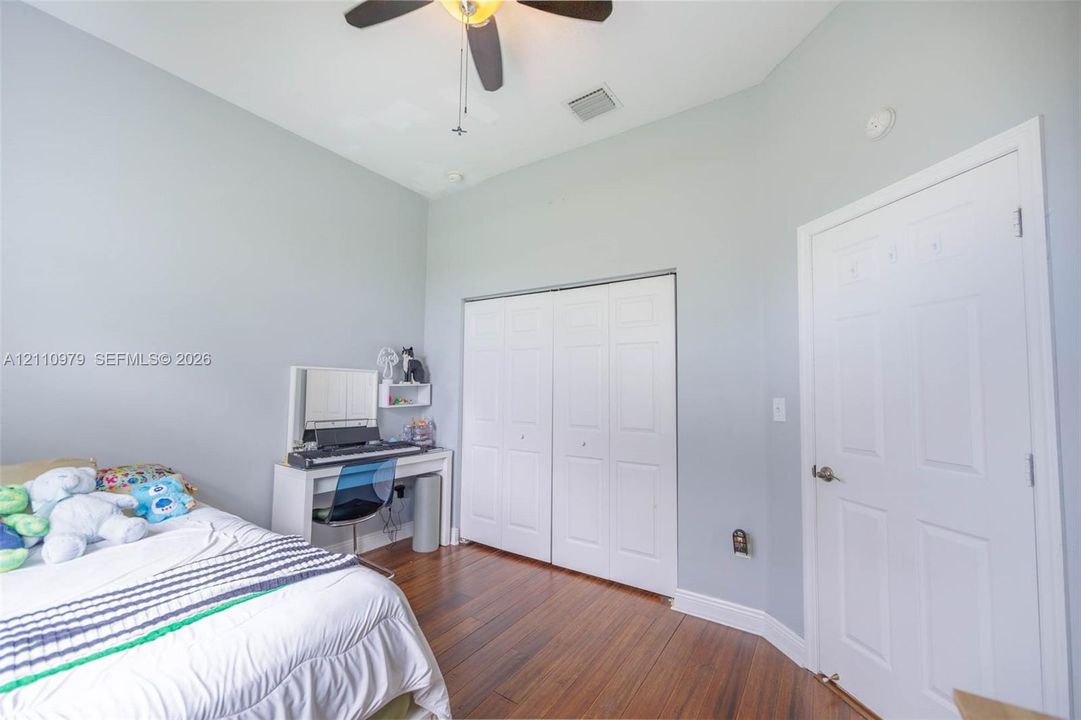 Vaulted ceilings, wood-finish flooring, and a ceiling fan with integrated lighting