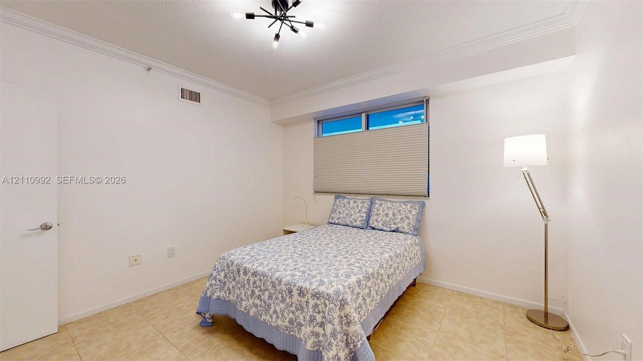 Neutral interior featuring tile flooring, crown molding, and a multi-arm geometric ceiling fixture