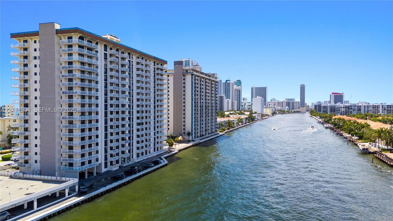 High-rise residential building featuring private cantilevered balconies, waterfront positioning, and concrete construction