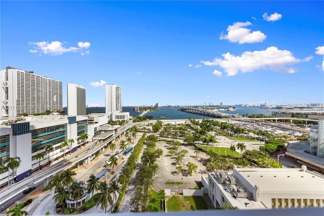 Elevated coastal perspective featuring expansive water, bridge, and cityscape scenery