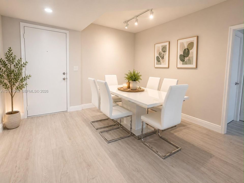 Neutral-toned interior featuring wood-finish flooring, recessed lighting, and adjustable multi-bulb track lighting