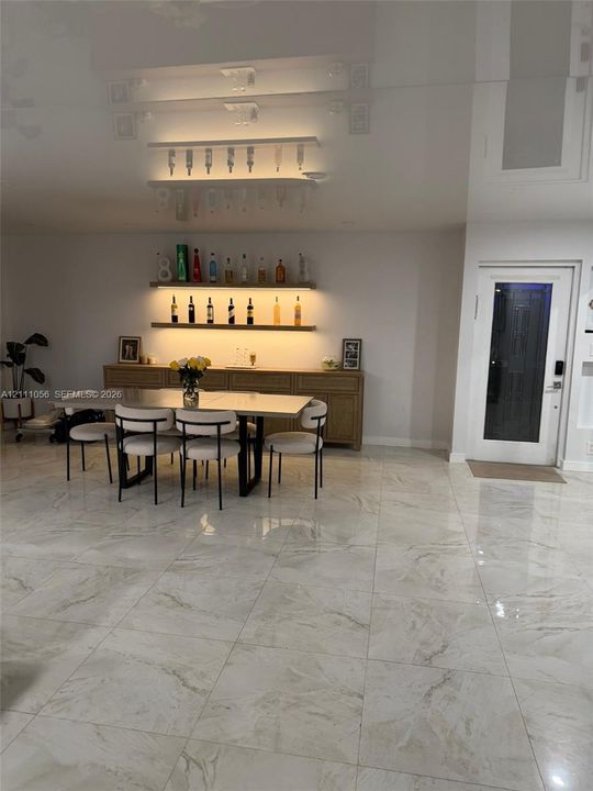 Large-format tile flooring, recessed ceiling lighting, and smart thermostat interface
