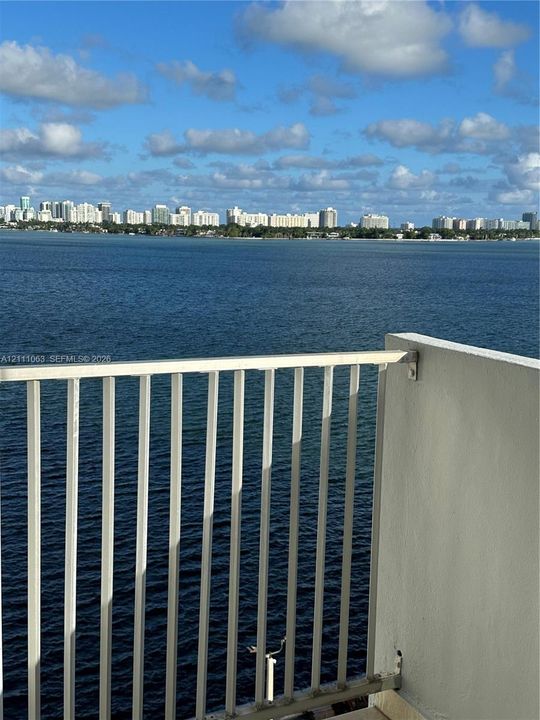 Balcony featuring a metal railing and unobstructed water scenery