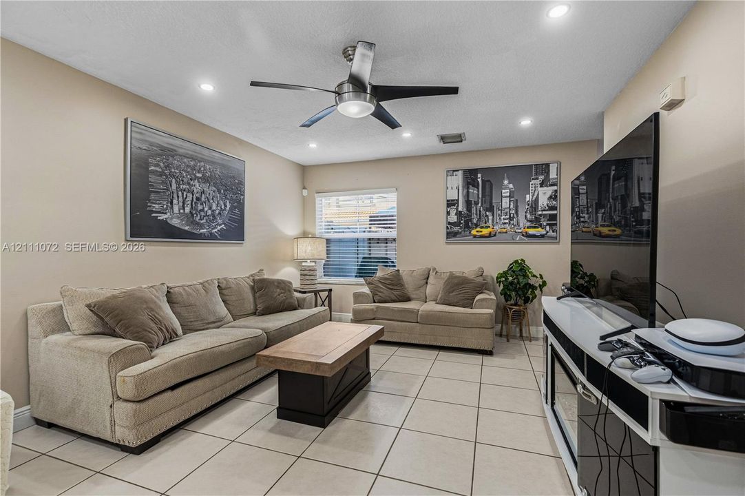 Living area featuring tile flooring, recessed lighting, and a ceiling fan