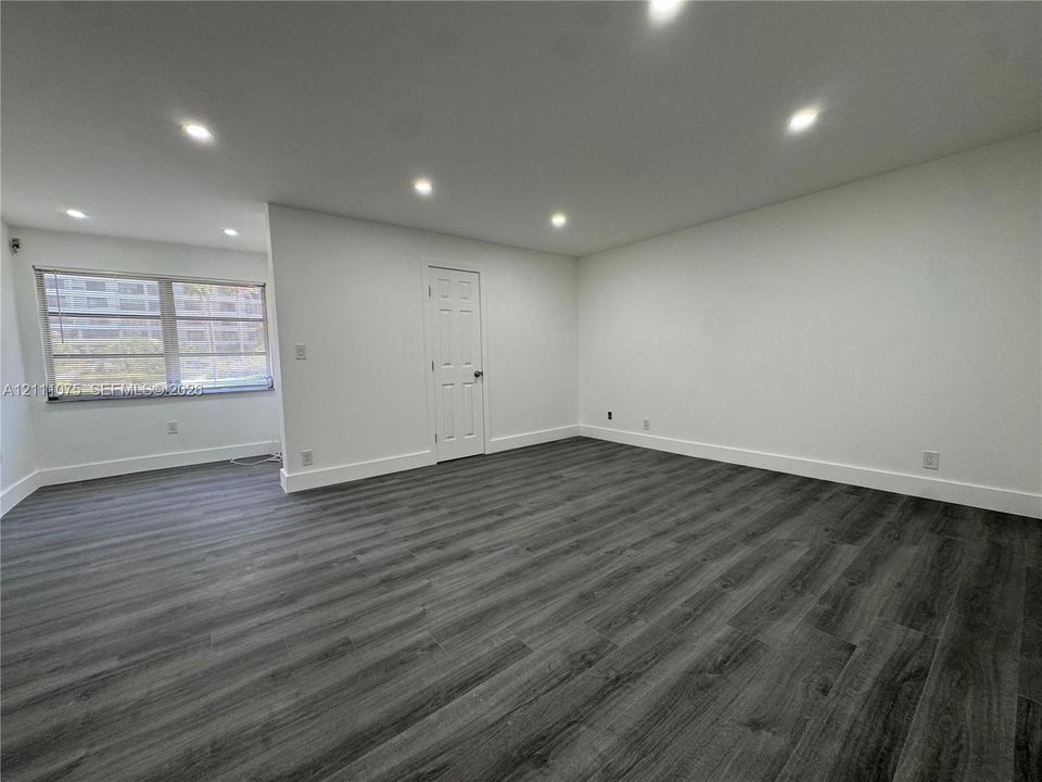 Interior space featuring wood-finish flooring, recessed lighting, and a neutral color palette
