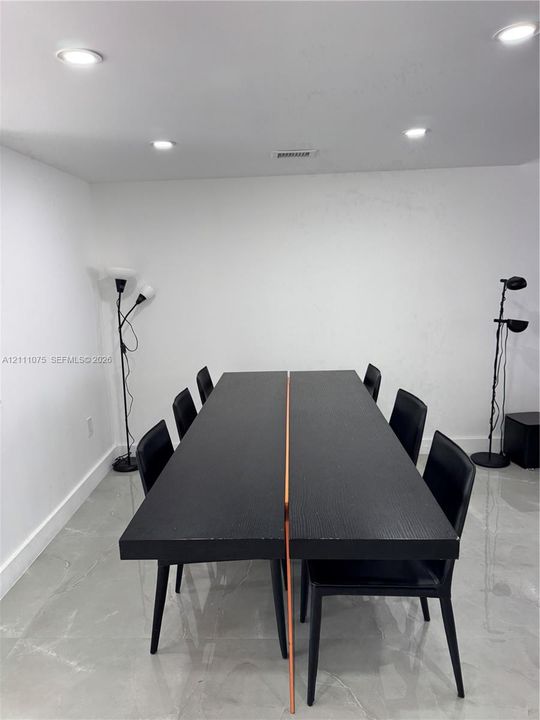 Neutral walls paired with high-gloss tile flooring and recessed overhead lighting