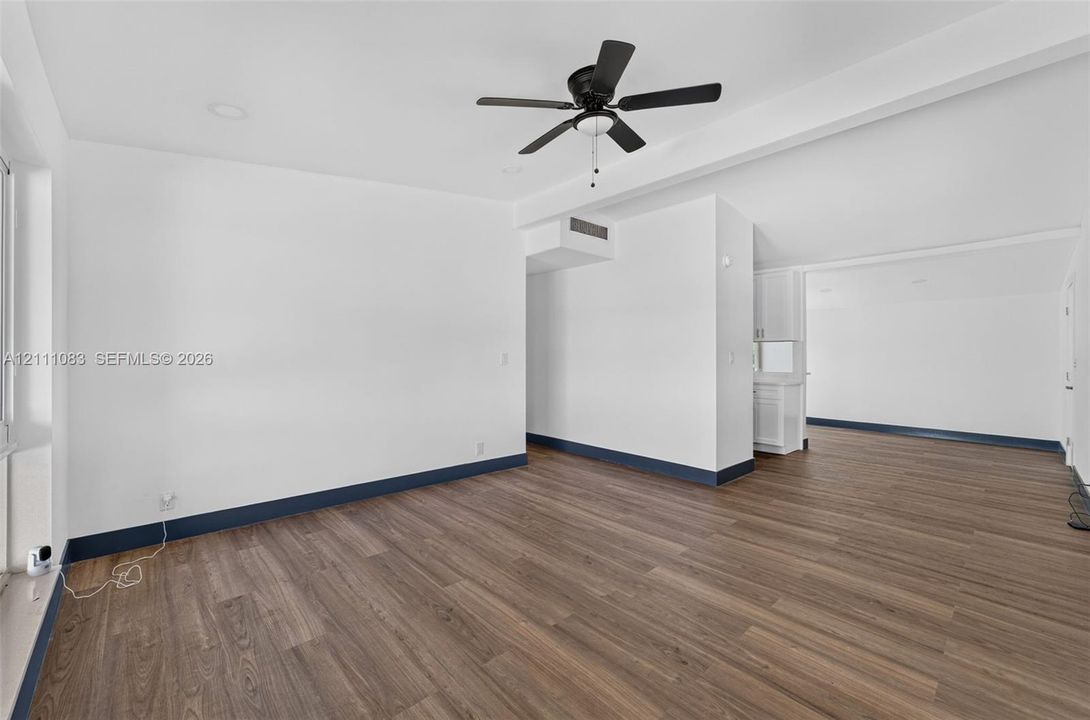 Interior space featuring wood-finish flooring, vaulted ceilings, recessed lighting, and a ceiling fan