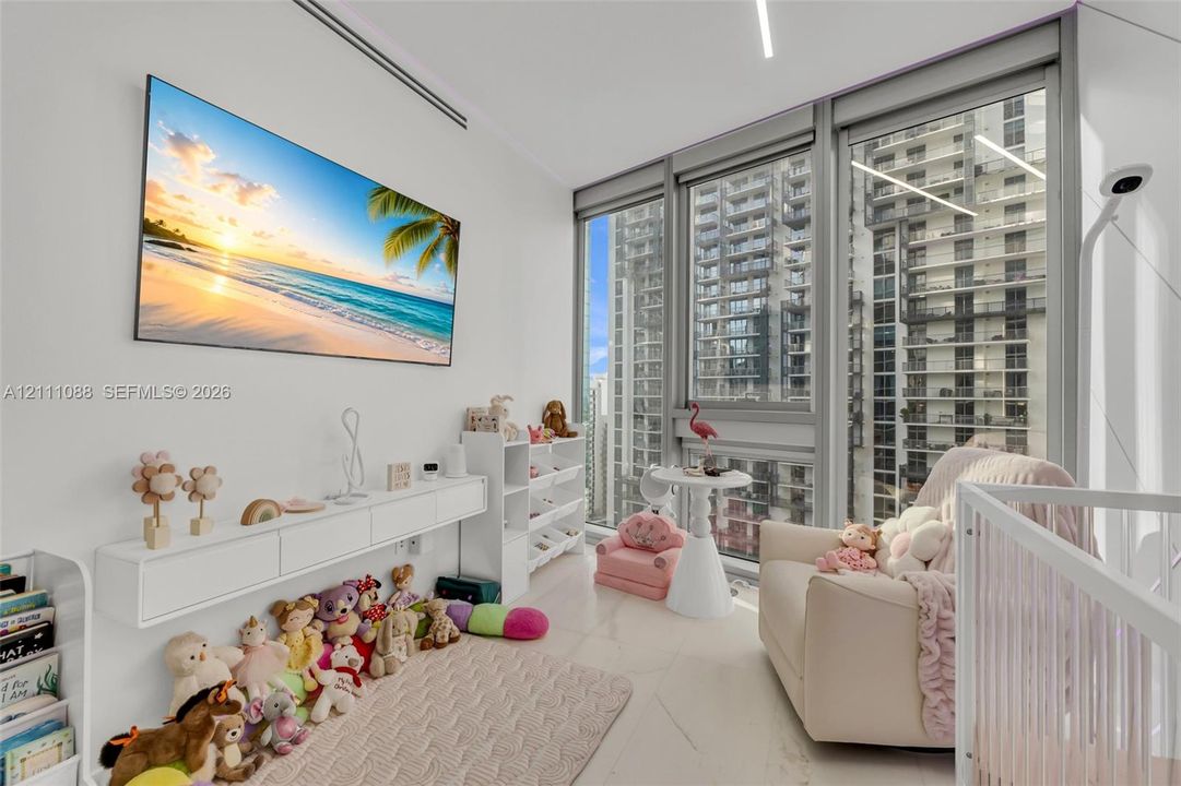 Floor-to-ceiling windows with expansive urban outlooks, light-toned stone-finish flooring, wall-mounted white cabinetry, and recessed linear LED lighting