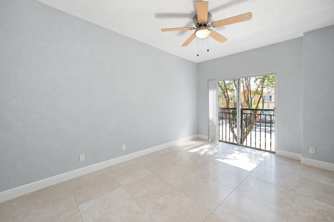 Bright Empty Room with Ceiling Fan and B