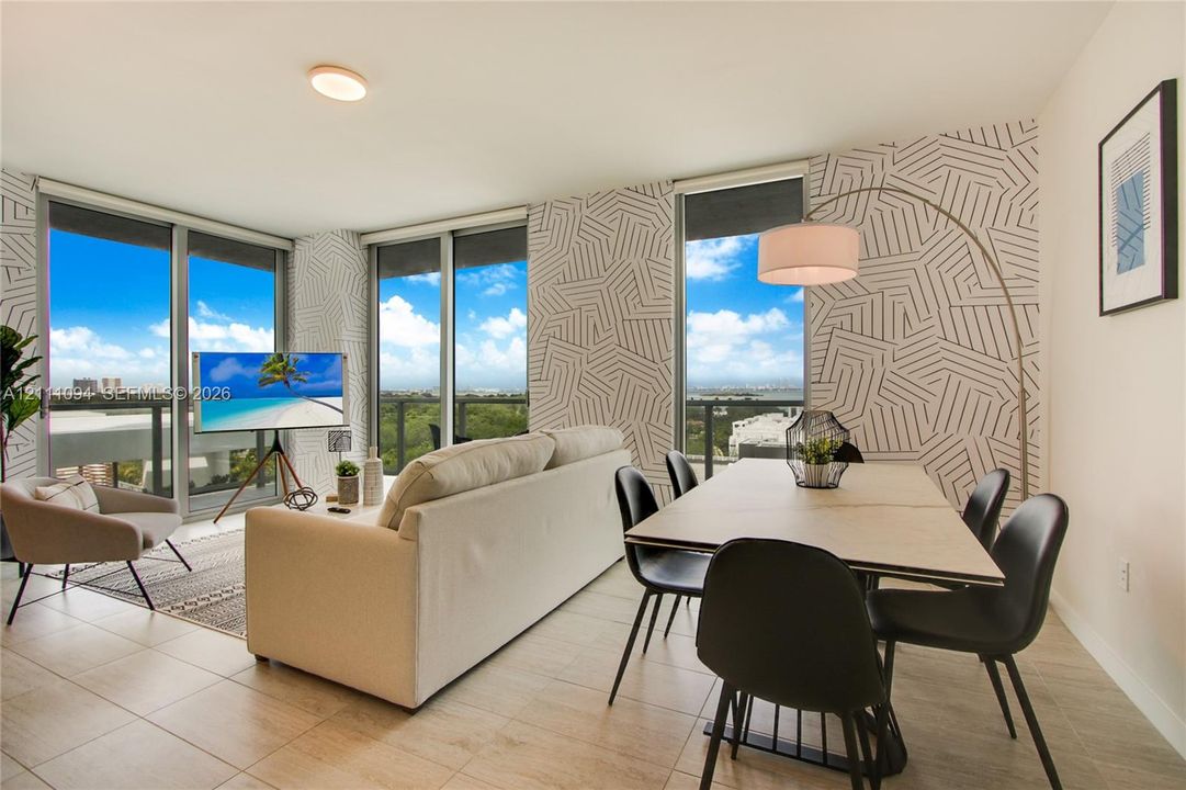 Floor-to-ceiling windows, ceramic tile flooring, geometric accent wall, and ceiling-mounted lighting