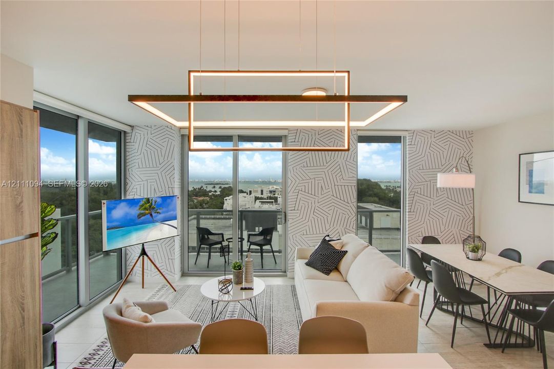Modern linear rectangular pendant light fixture, floor-to-ceiling glass sliding doors, and patterned wall covering