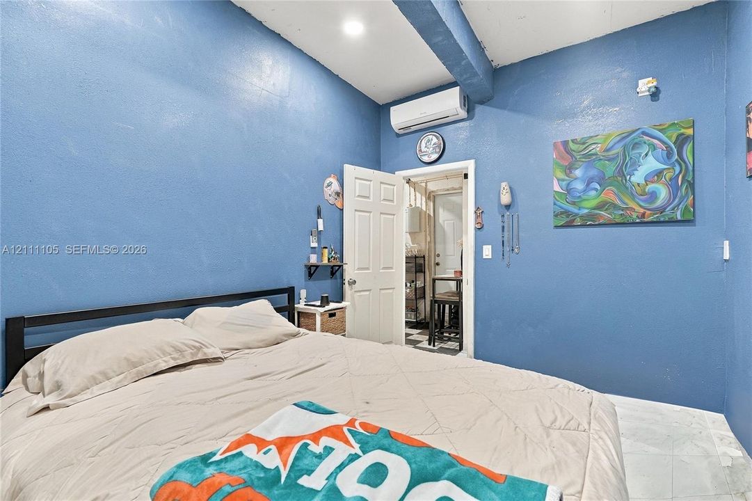 Interior space featuring recessed lighting, a mounted ductless mini-split air conditioning unit, and white tile flooring