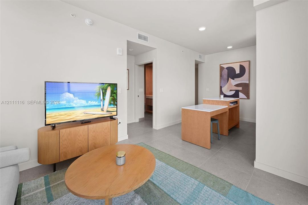 Neutral-toned interior featuring expansive tile flooring and recessed lighting