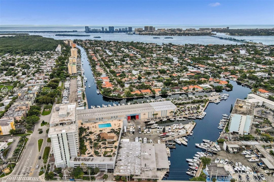 Aerial perspective featuring a waterfront location with direct canal access, deep-water docking, and a swimming pool