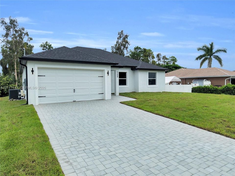 Angled view of the 2-car garage and paved driveway.