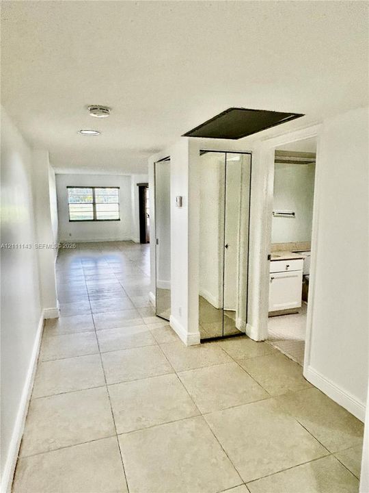 Ceramic tile flooring, dual mirrored closet doors, and recessed ceiling lighting