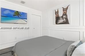 White wainscoting wall paneling and a solid-core interior door