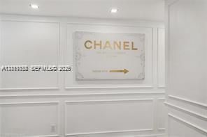 Wall surfaces featuring recessed picture frame molding and integrated recessed ceiling lighting