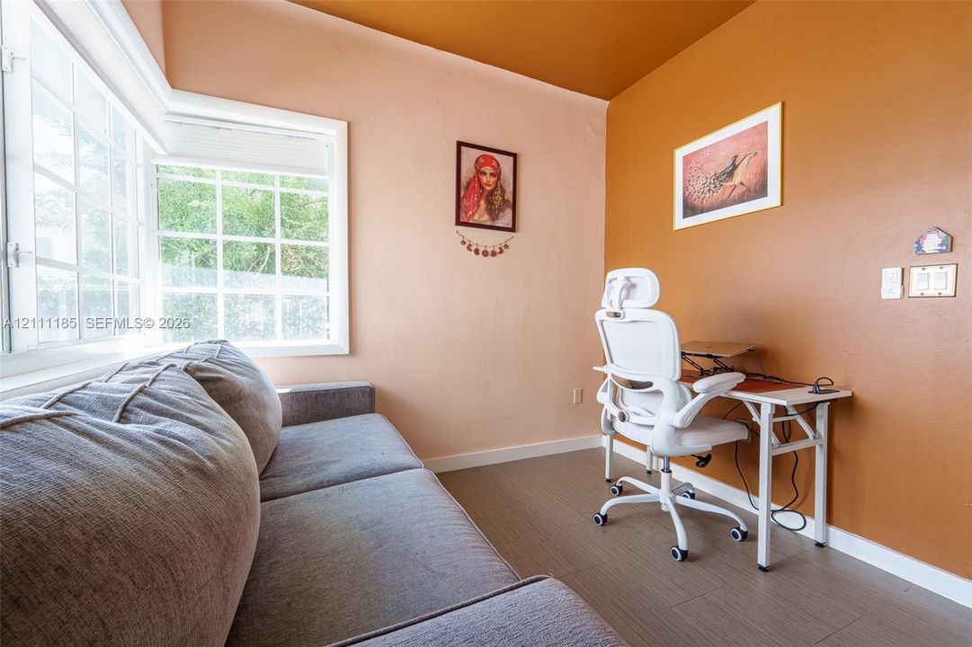 Interior room featuring wood-finish flooring and a multi-pane bay window