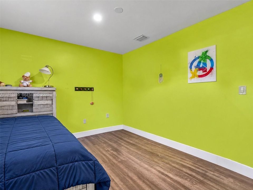 Room featuring wood-finish flooring and recessed ceiling lighting