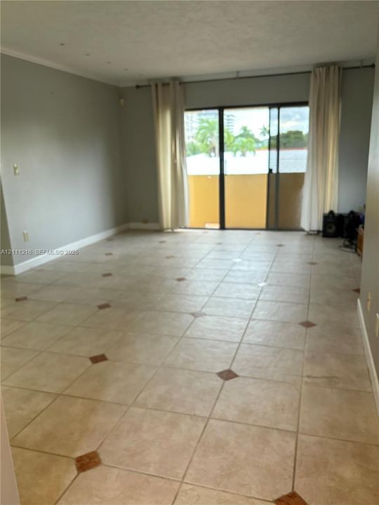 Interior space featuring tile flooring with decorative stone accents and sliding glass doors providing external access