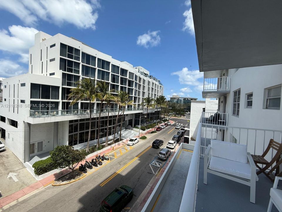 Elevated outdoor balcony with metal railings and concrete flooring