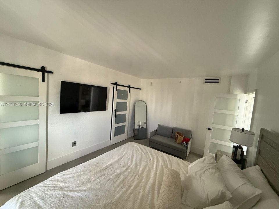 Multiple interior doors featuring white frames and translucent frosted glass panels with black hardware