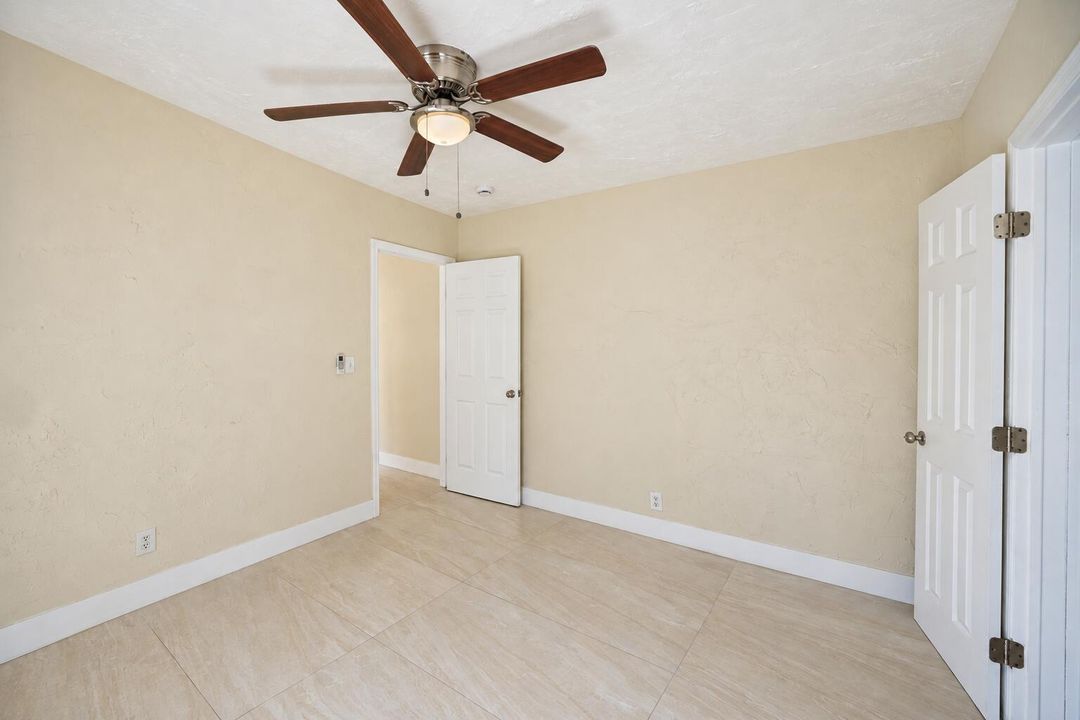 Bright Empty Beige Room with Ceiling Fan