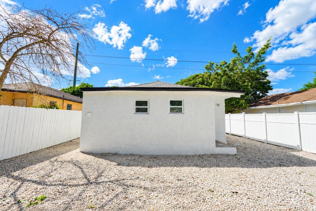 Bright Stucco Backyard Under Blue Skies