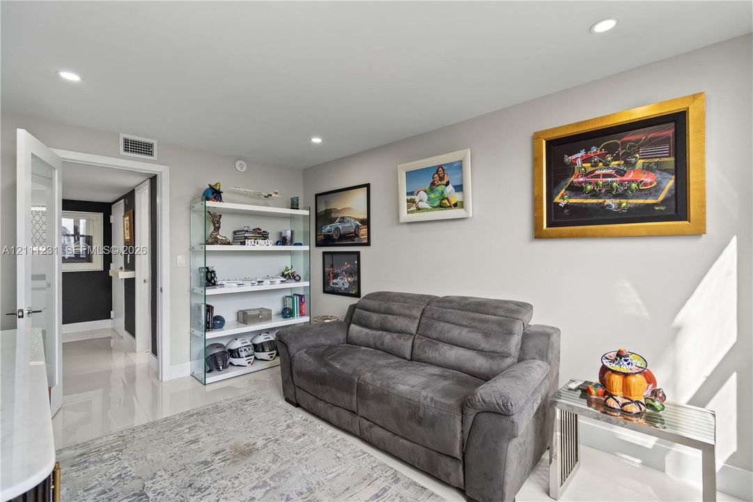 Neutral interior space featuring polished tile flooring, recessed lighting, and a neutral wall color palette