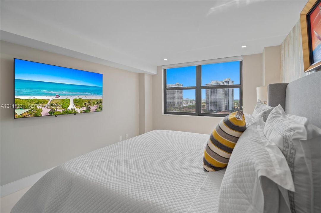 Large window with dark-toned frame and recessed ceiling lighting