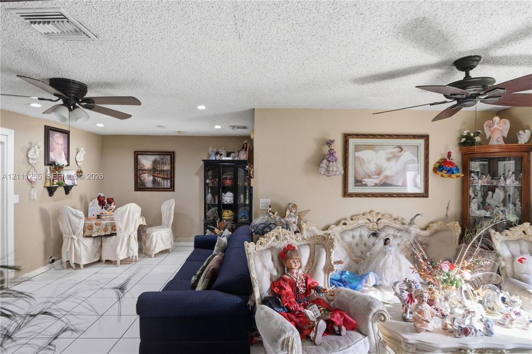 Interior space featuring white tile flooring, recessed lighting, and dual ceiling fans