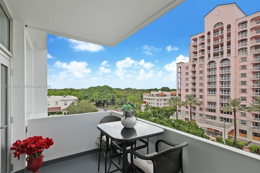 Covered balcony with solid concrete walls and dark flooring